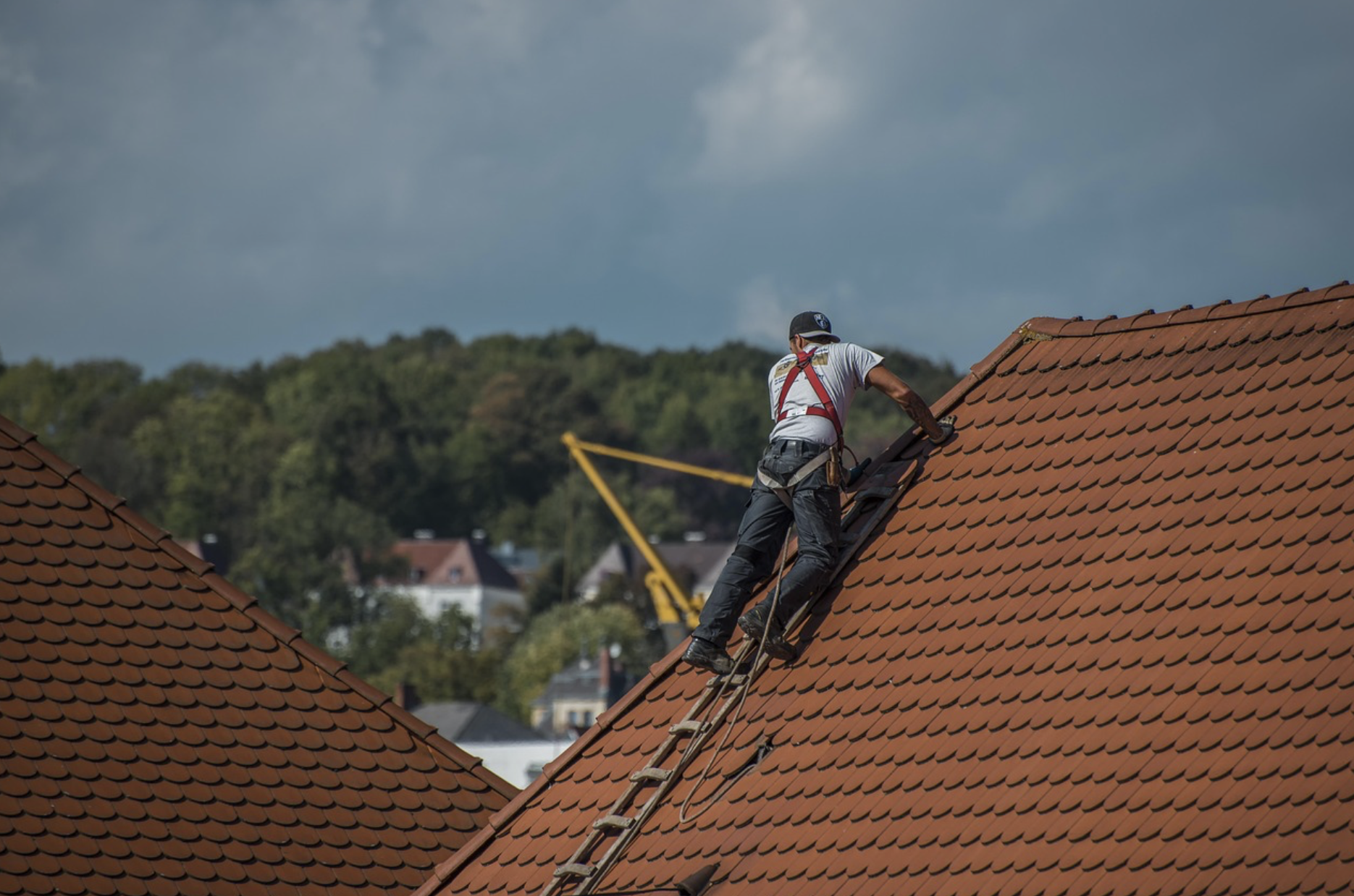 Roofer at work on a slate roof